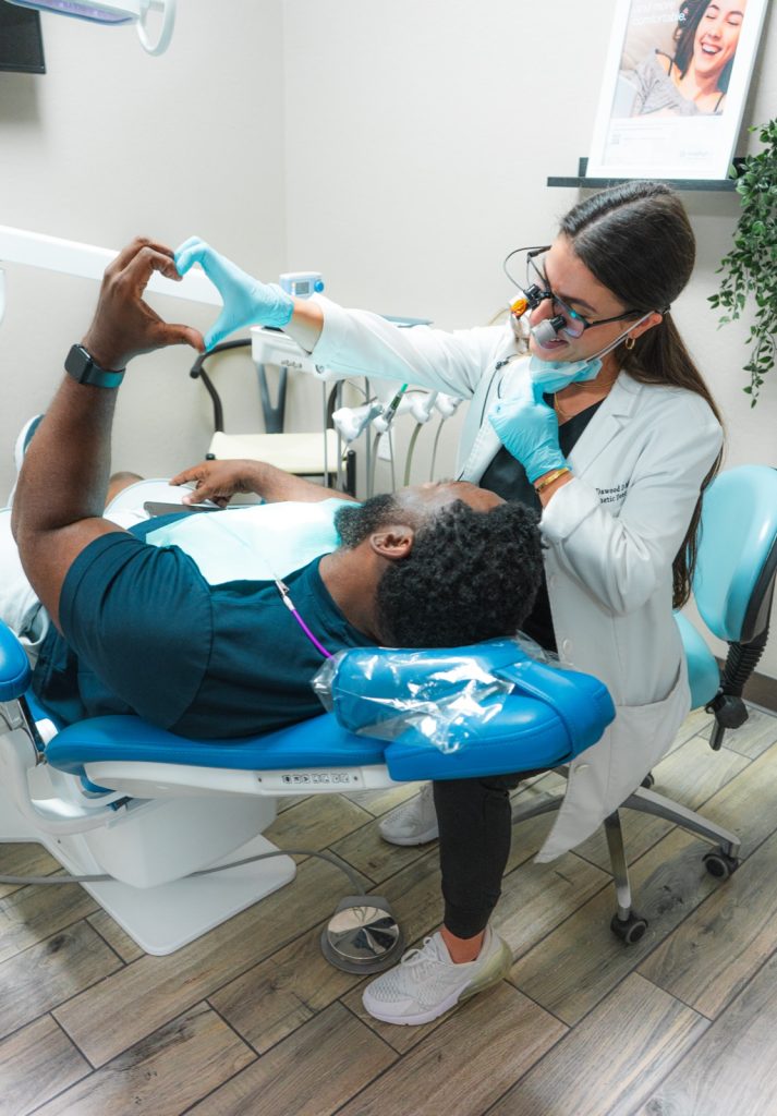 Dr. Dawood using 3D imaging technology with a patient during an implant consultation