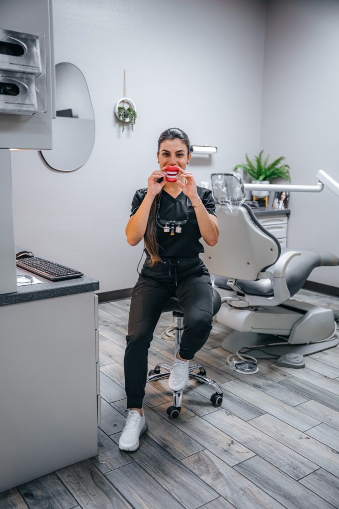 Glisten Dental team member with smile retractor